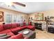 Inviting living room featuring a plush red sectional sofa, fireplace, and neutral tones for a cozy atmosphere at 1502 Oxbow Ct, Henderson, NV 89014