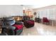 Bright living room with tile flooring, a comfortable seating area, and a dedicated workspace with natural light at 1502 Oxbow Ct, Henderson, NV 89014