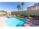 A serene private pool features lounge chairs and a charming landscaped garden area at 1502 Oxbow Ct, Henderson, NV 89014