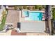 Aerial view of a private pool with a spa, patio, and lounge chairs in a well-maintained backyard at 1502 Oxbow Ct, Henderson, NV 89014