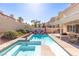 Relax in this backyard pool with its attached spa and well-manicured landscaping at 1502 Oxbow Ct, Henderson, NV 89014