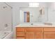 Bathroom features a white sink, wooden cabinets, vanity mirror, and shower at 1513 Brocado Ln, Las Vegas, NV 89117