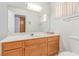 Bathroom features a white sink, wooden cabinets, and vanity mirror at 1513 Brocado Ln, Las Vegas, NV 89117