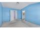 Bedroom with blue walls and doorway to bathroom at 1513 Brocado Ln, Las Vegas, NV 89117