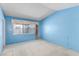 Simple bedroom with blue walls and neutral carpet at 1513 Brocado Ln, Las Vegas, NV 89117