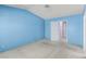 Blue bedroom featuring a neutral carpet and white door at 1513 Brocado Ln, Las Vegas, NV 89117