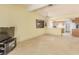 Bright living room open to the kitchen, ceiling fan, and large windows for natural lighting at 1513 Brocado Ln, Las Vegas, NV 89117