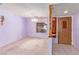 Living room featuring light purple walls, carpeted floors, and a large window providing natural light at 1513 Brocado Ln, Las Vegas, NV 89117
