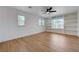 Bright bedroom featuring wood floors, built-in shelves, and a ceiling fan at 1624 Ravanusa Dr, Henderson, NV 89052