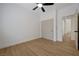 Simple bedroom with hardwood floors, closet, and a view into the hallway at 1624 Ravanusa Dr, Henderson, NV 89052
