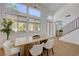Elegant dining room with high ceilings, large windows, and a modern chandelier at 1624 Ravanusa Dr, Henderson, NV 89052