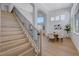 Dining area with modern chandelier, large windows and open access to staircase at 1624 Ravanusa Dr, Henderson, NV 89052
