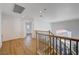 Second floor hallway features wood floors and wrought iron railings at 1624 Ravanusa Dr, Henderson, NV 89052