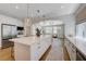 Open concept kitchen featuring large island, stainless appliances, and seamless flow into living area at 1624 Ravanusa Dr, Henderson, NV 89052