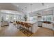 Open kitchen featuring a large island with seating, stainless steel appliances, and an open concept floorplan at 1624 Ravanusa Dr, Henderson, NV 89052
