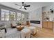 Cozy living room with a modern fireplace, built-in shelves, and natural light at 1624 Ravanusa Dr, Henderson, NV 89052