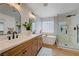 Bright bathroom features dual sinks, standalone tub, and glass shower enclosure at 1624 Ravanusa Dr, Henderson, NV 89052