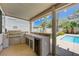 Outdoor kitchen and barbecue area near the pool at 1624 Ravanusa Dr, Henderson, NV 89052