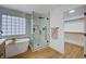 Spa-like bathroom features modern tub, glass enclosed shower, and natural light at 1624 Ravanusa Dr, Henderson, NV 89052