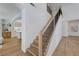 Open staircase features wood treads, black metal railings and light wood flooring at 1624 Ravanusa Dr, Henderson, NV 89052