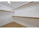 Walk in closet features wood shelving and wood flooring at 1624 Ravanusa Dr, Henderson, NV 89052