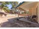 Covered backyard patio features a grill, table, and chairs at 165 Spinnaker Dr, Henderson, NV 89015