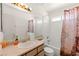 Bathroom features a shower-tub combo, a vanity, large mirror, and window at 165 Spinnaker Dr, Henderson, NV 89015