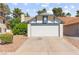 Charming home with a large white garage door and blue trim, complemented by a well-maintained front lawn at 165 Spinnaker Dr, Henderson, NV 89015