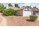 Charming single-Gathering home featuring a two-car garage, complemented by mature trees and desert landscaping at 165 Spinnaker Dr, Henderson, NV 89015