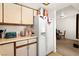 Well-organized kitchen with ample cabinet space, modern refrigerator, and convenient dining area access at 165 Spinnaker Dr, Henderson, NV 89015