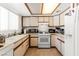 Efficient kitchen with white appliances, ample countertop space, and a neutral color scheme at 165 Spinnaker Dr, Henderson, NV 89015