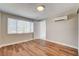 Bright bedroom featuring wood floors, a window for natural light and air conditioning at 1708 Cedar Ave, Las Vegas, NV 89101