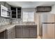 Galley kitchen featuring stainless steel appliances, gray cabinets and tile backsplash at 1708 Cedar Ave, Las Vegas, NV 89101