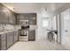 Galley kitchen features gray cabinets, stainless appliances, and a stone backsplash at 1708 Cedar Ave, Las Vegas, NV 89101