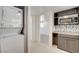 Bright kitchen featuring modern appliances, gray cabinetry, and a stacked washer and dryer unit at 1708 Cedar Ave, Las Vegas, NV 89101