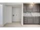 Kitchen featuring gray cabinetry, stainless steel sink, tiled backsplash, and washer-dryer hookups at 1708 Cedar Ave, Las Vegas, NV 89101