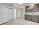 Well-lit kitchen with gray cabinets, stainless steel appliances, and adjacent laundry area at 1708 Cedar Ave, Las Vegas, NV 89101