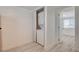 Neat laundry closet features stacked washer and dryer and a nearby doorway, with wood-look vinyl flooring at 1708 Cedar Ave, Las Vegas, NV 89101