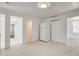 Open living area features light wood-look floors, white walls, mini-split system, and adjacent kitchen at 1708 Cedar Ave, Las Vegas, NV 89101