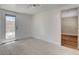 Open living area features light wood-look floors and access to backyard at 1708 Cedar Ave, Las Vegas, NV 89101