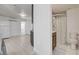 Open living area features light wood-look floors, mini-split system, and bathroom at 1708 Cedar Ave, Las Vegas, NV 89101