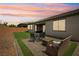 Secluded backyard oasis with artificial grass, outdoor dining set, and cozy seating area at 172 Lunga Ave, Henderson, NV 89011