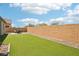 Spacious backyard with artificial grass, a patio area, and privacy wall at 172 Lunga Ave, Henderson, NV 89011