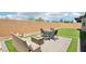 Inviting backyard featuring artificial turf, brick pavers, and outdoor seating area with a fire pit at 172 Lunga Ave, Henderson, NV 89011