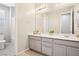 Bright bathroom features double vanity, large mirror, and tub with shower at 172 Lunga Ave, Henderson, NV 89011
