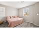 Neutral bedroom with plush carpet, large bed, and natural light from window at 172 Lunga Ave, Henderson, NV 89011