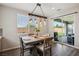 This charming dining area features a modern light fixture and sliding doors to the patio at 172 Lunga Ave, Henderson, NV 89011
