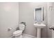 This powder room features a pedestal sink, round mirror, and decorative accents at 172 Lunga Ave, Henderson, NV 89011