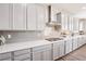 Bright kitchen with white cabinets, quartz countertops, and stainless steel appliances at 172 Lunga Ave, Henderson, NV 89011