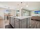 Bright kitchen with a large island and a view into the dining and living areas at 172 Lunga Ave, Henderson, NV 89011